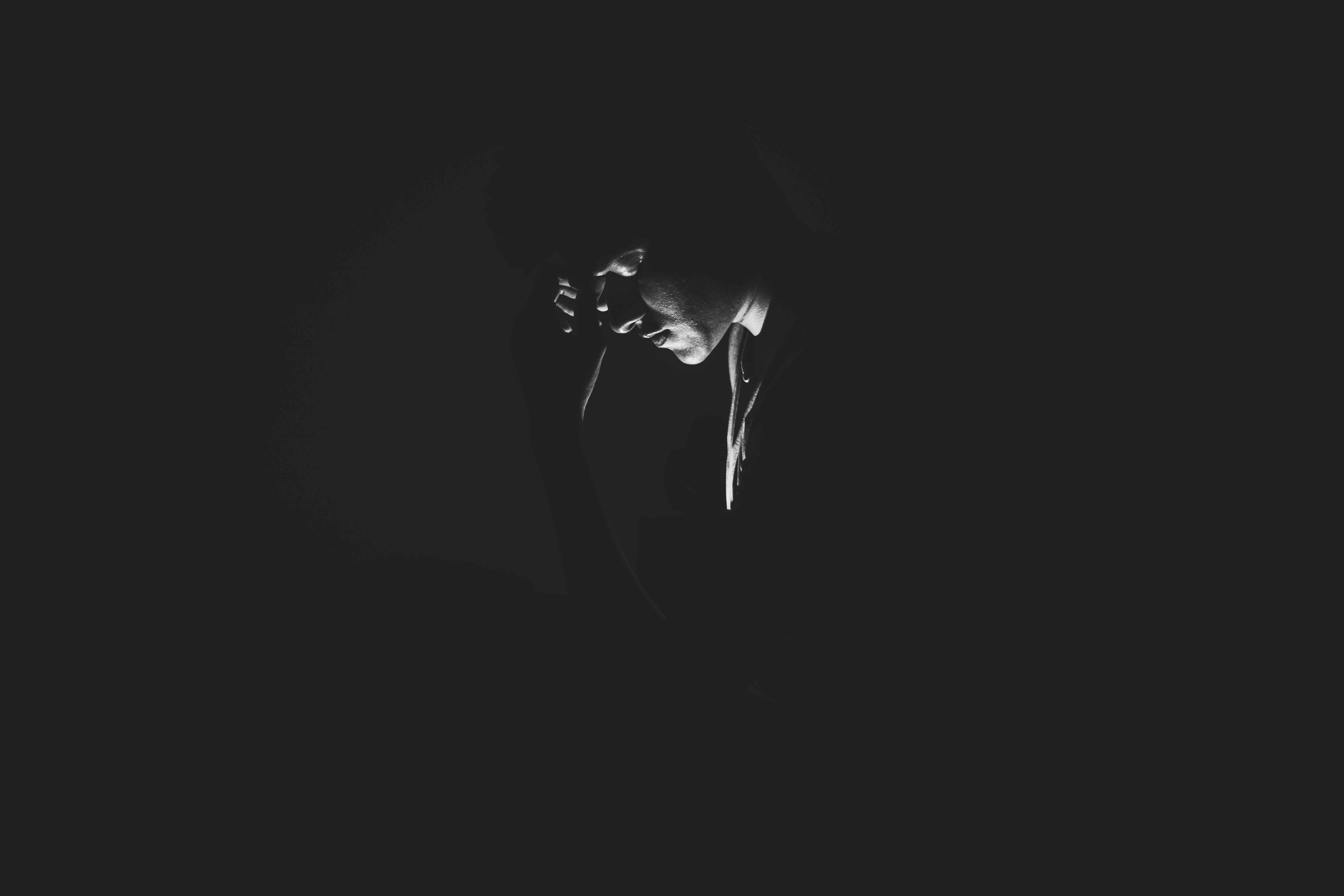 monochrome-photography-of-person-on-dark-room-1299417.jpg